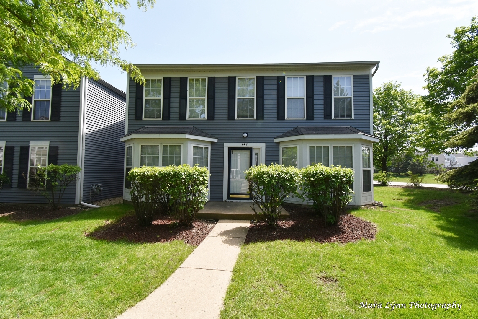 a front view of a house with garden and porch