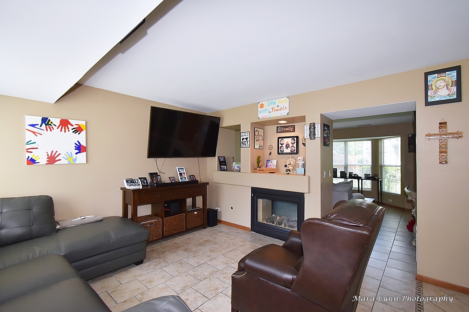 987 Symphony Drive Aurora, IL 60504 - Photo 11 of 27 a living room with furniture fireplace and flat screen tv