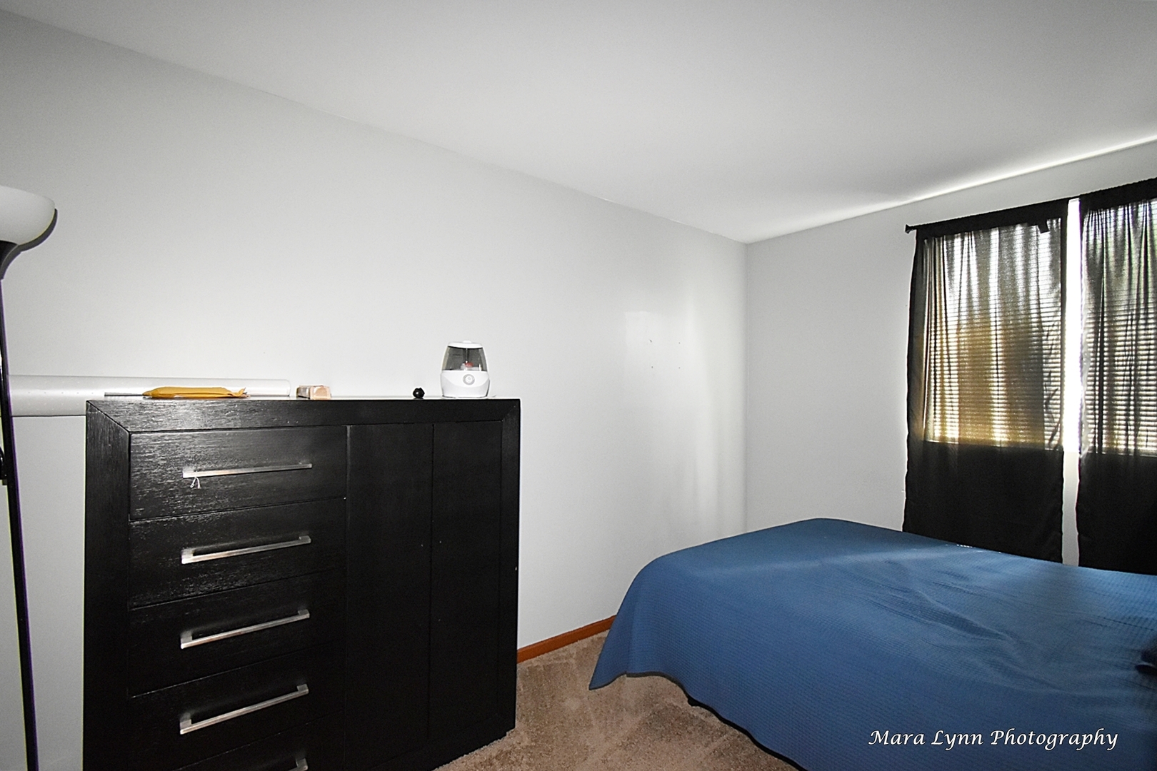 987 Symphony Drive Aurora, IL 60504 - Photo 20 of 27 a bedroom with a bed and a dresser
