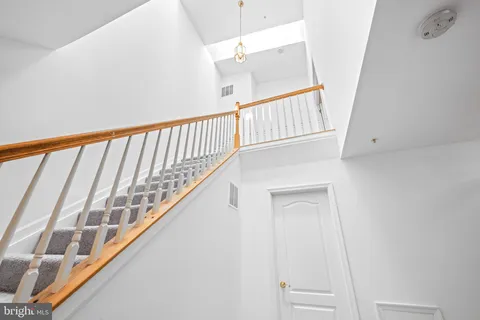 a view of staircase with white walls and a window