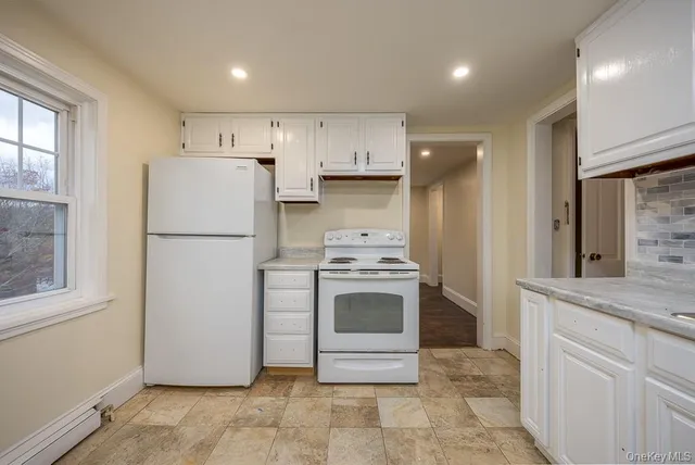 a kitchen with a refrigerator sink stove and cabinets