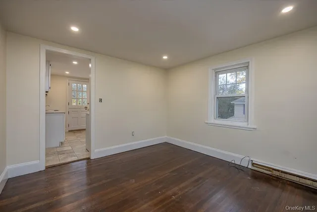 wooden floor in an empty room with a gallery