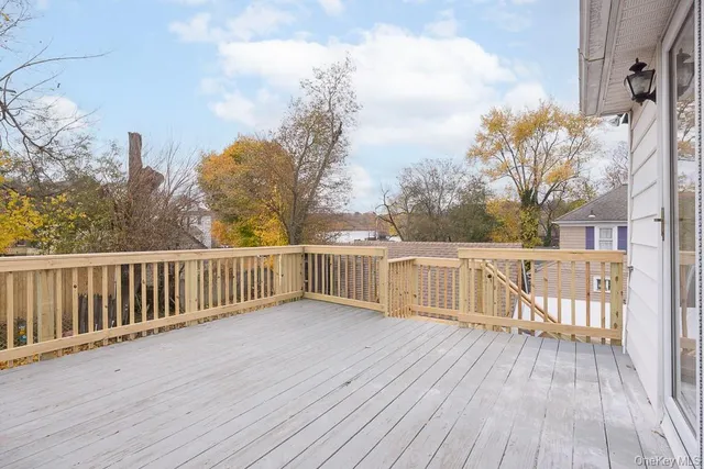 a view of balcony with wooden floor and fence