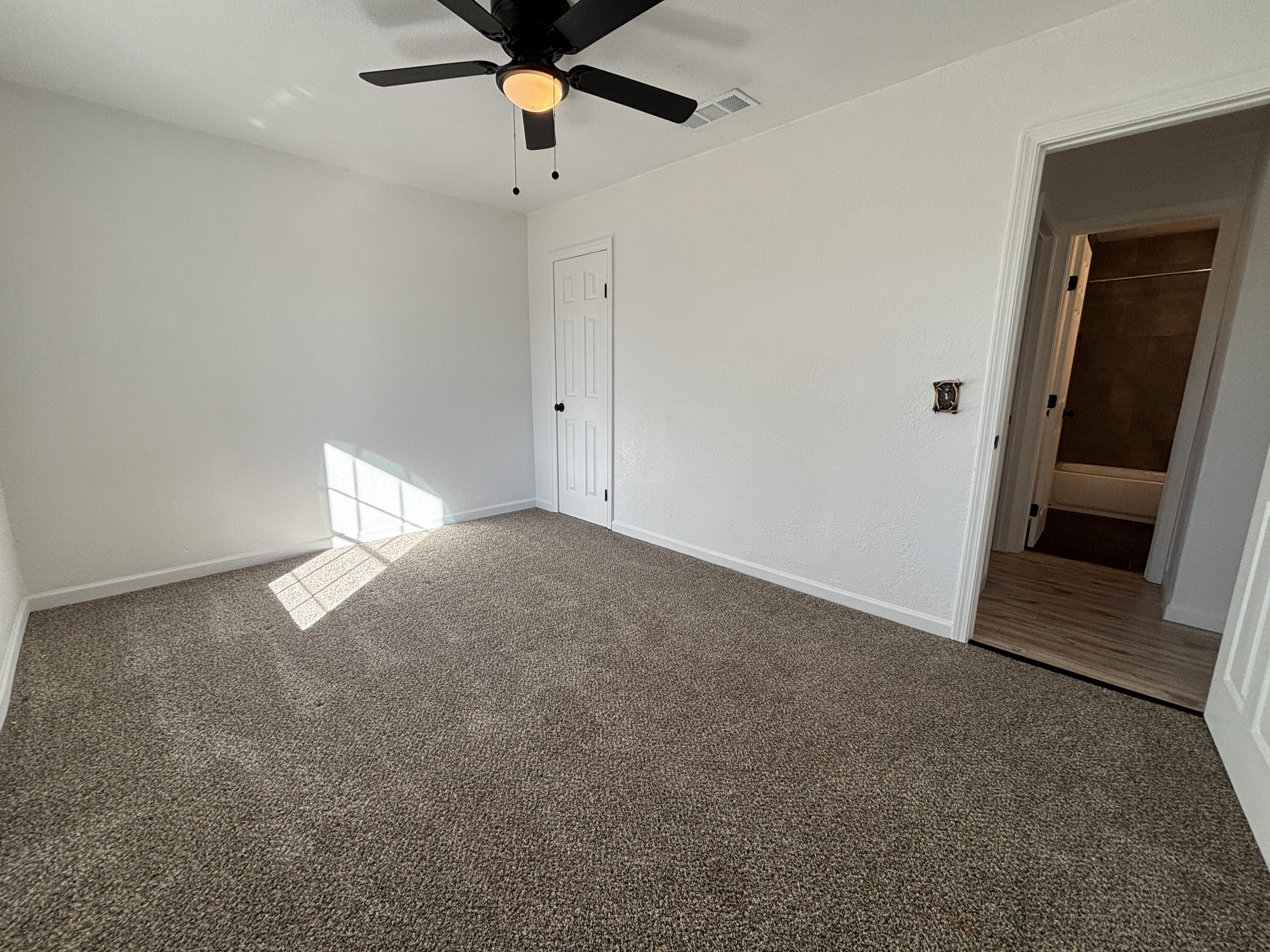 2718 Cornell Street Lubbock, TX 79415 - Photo 11 of 13 an empty room with a empty space and windows