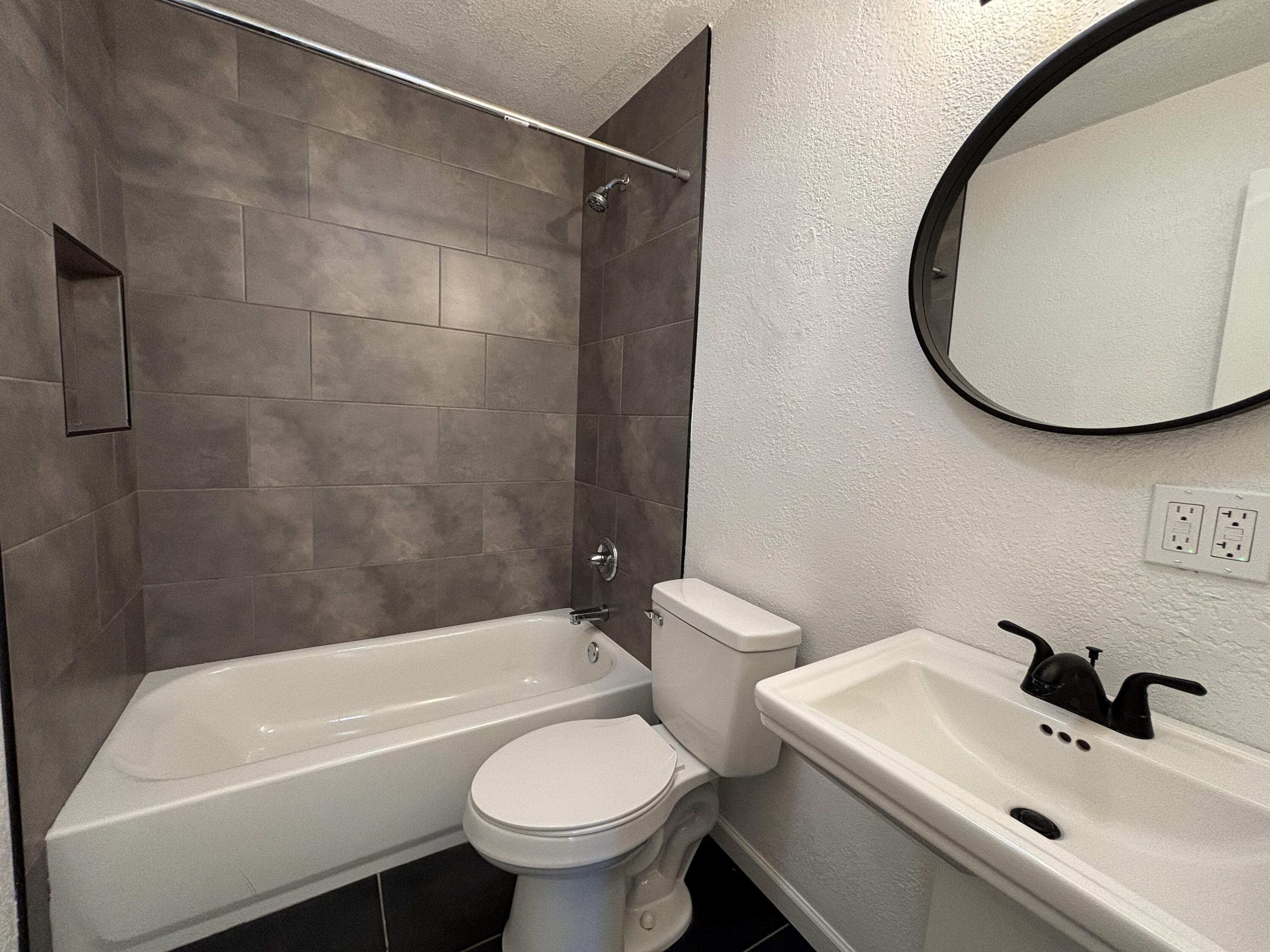 2718 Cornell Street Lubbock, TX 79415 - Photo 12 of 13 a bathroom with a sink and a mirror