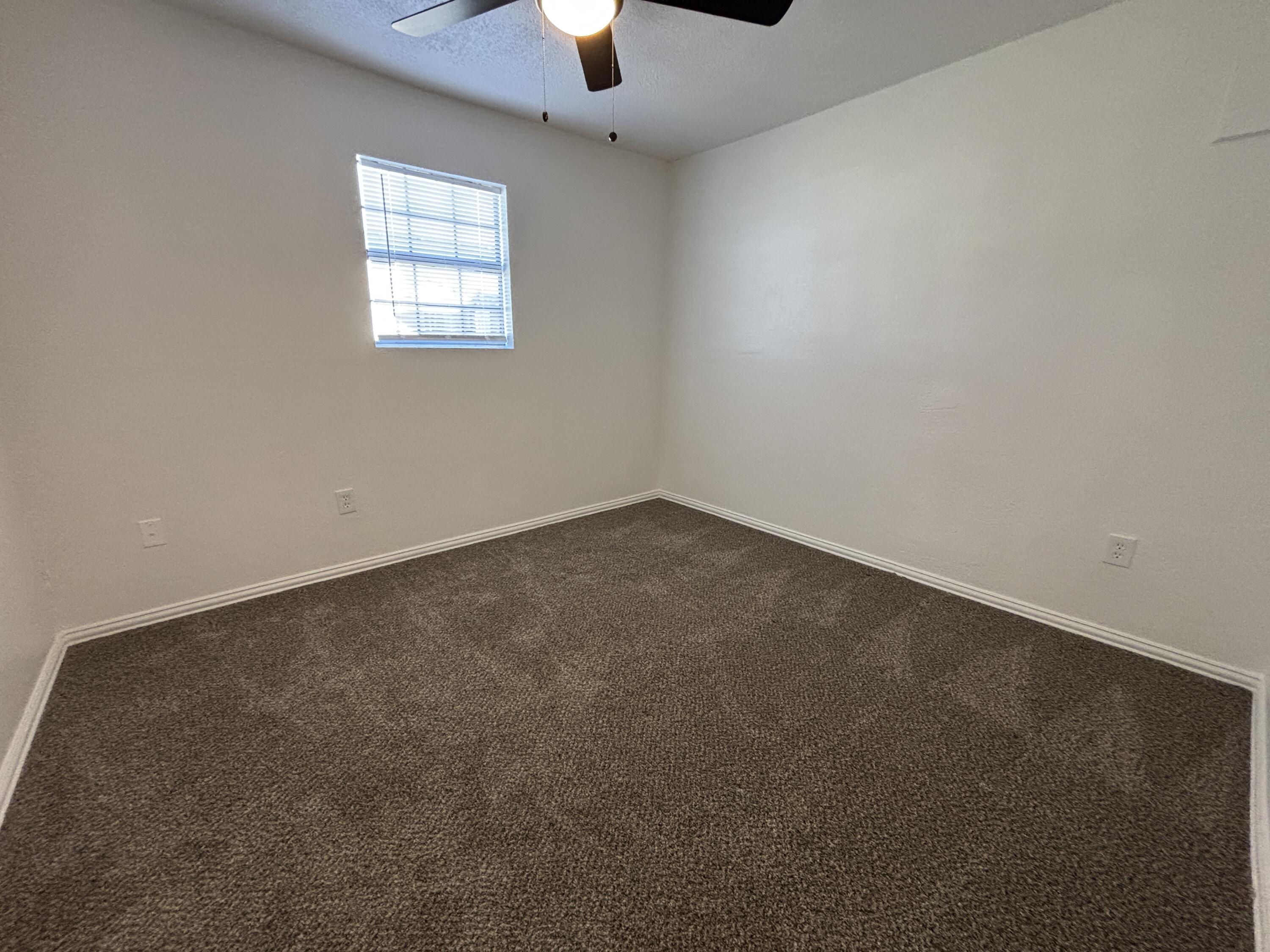 2718 Cornell Street Lubbock, TX 79415 - Photo 13 of 13 an empty room with a window
