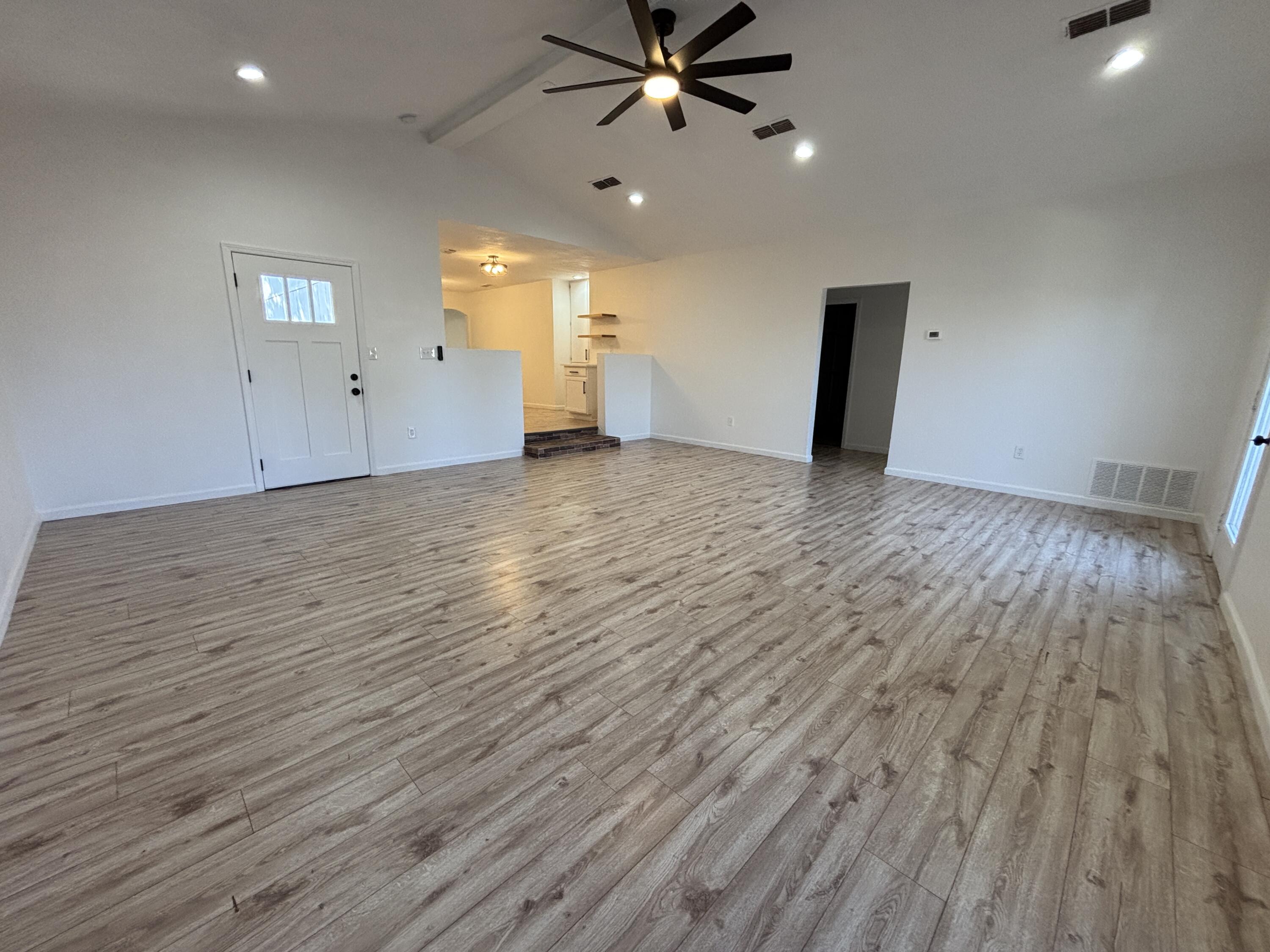 2718 Cornell Street Lubbock, TX 79415 - Photo 4 of 13 an empty room with wooden floor and windows