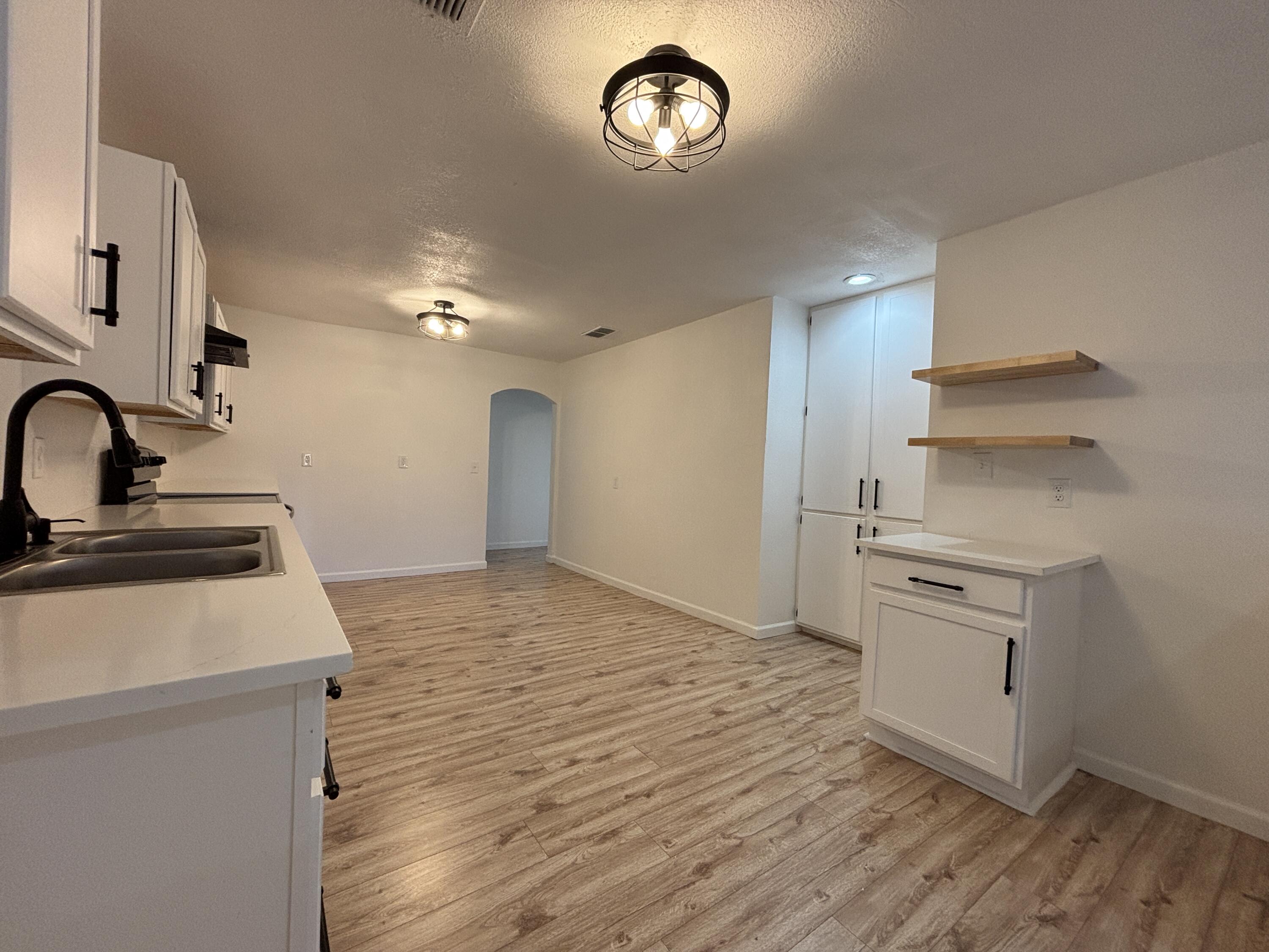 2718 Cornell Street Lubbock, TX 79415 - Photo 5 of 13 a kitchen with a sink cabinets stainless steel appliances and a refrigerator