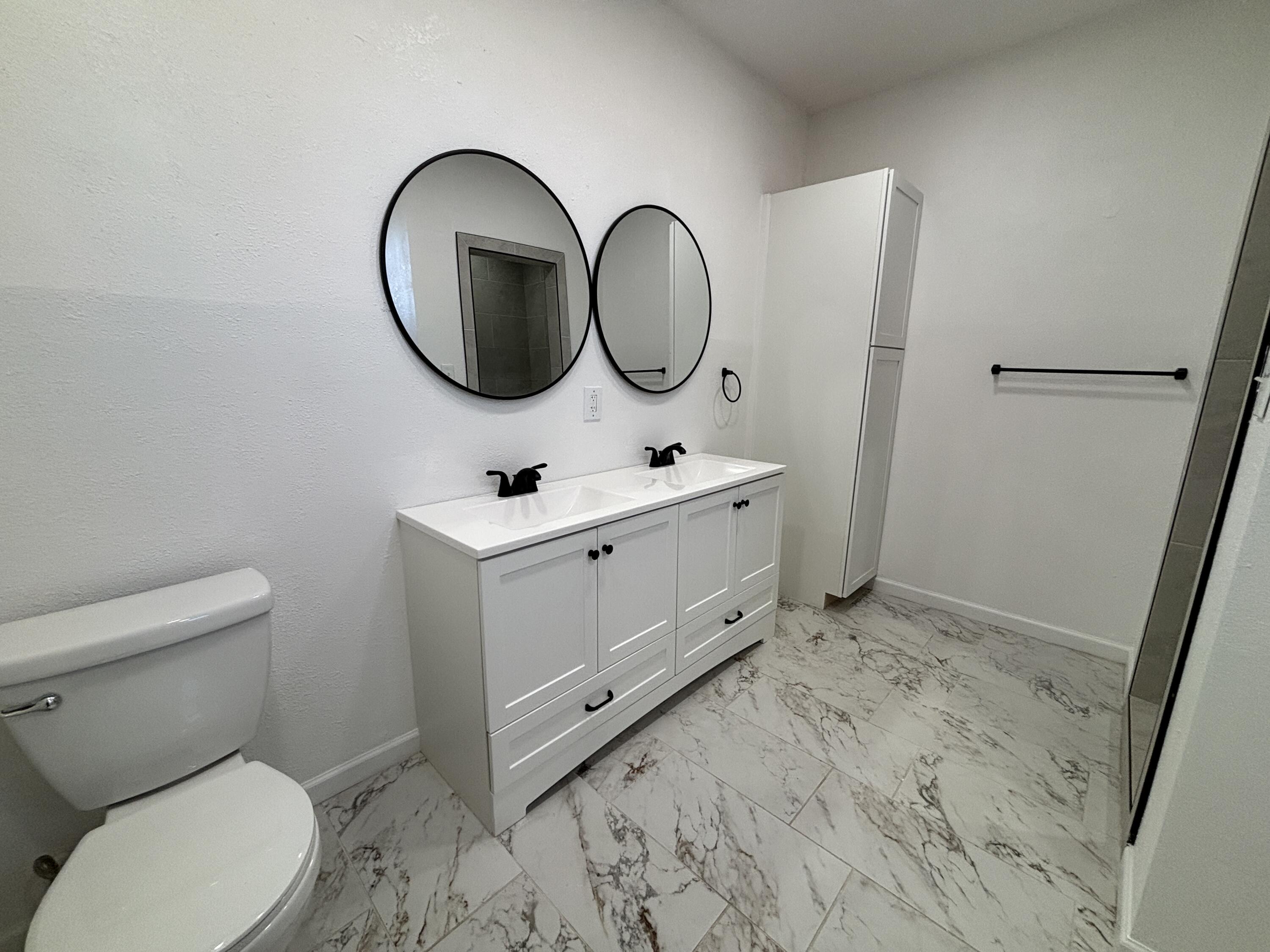 2718 Cornell Street Lubbock, TX 79415 - Photo 8 of 13 a bathroom with a toilet sink and mirror