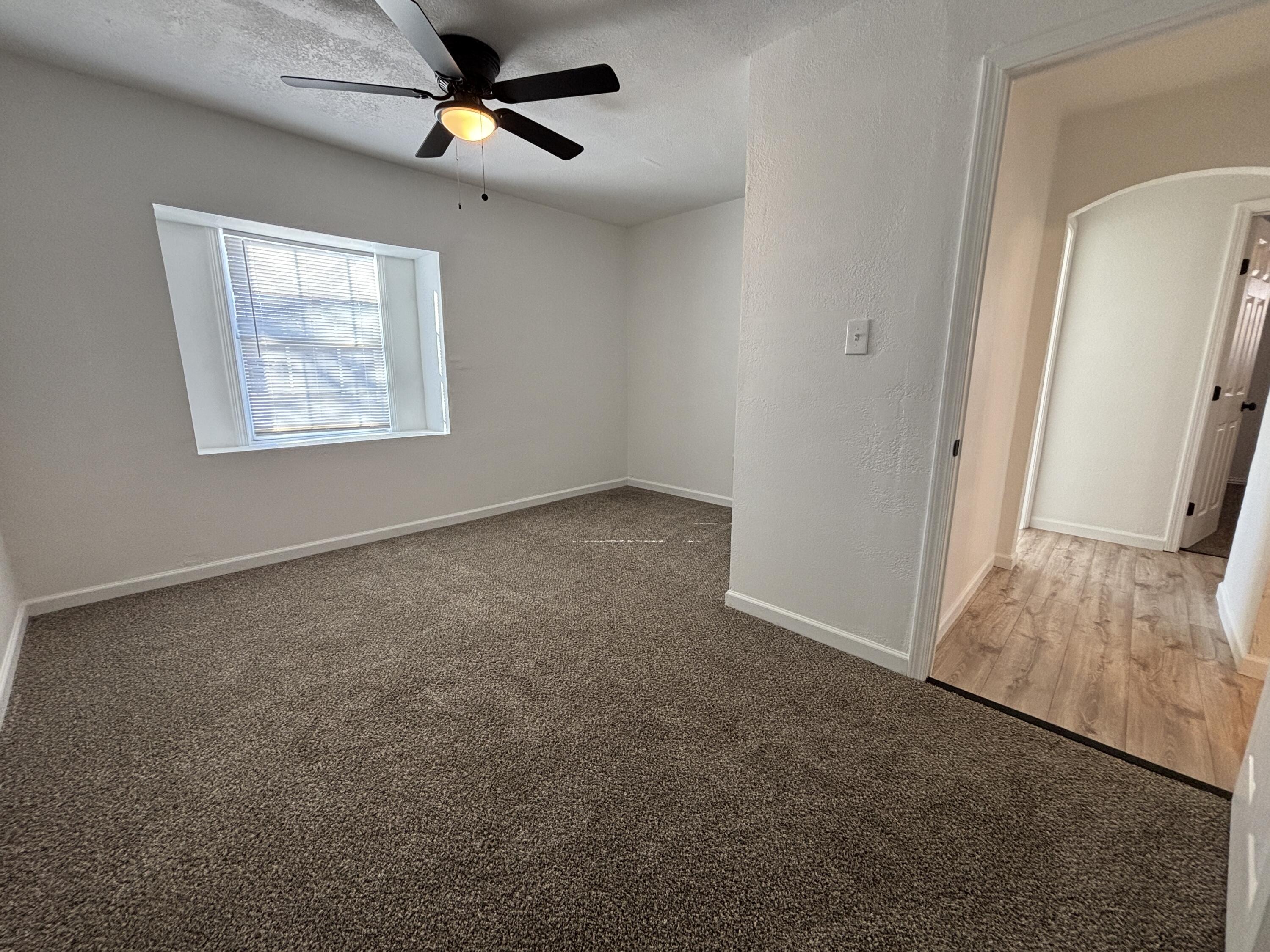 2718 Cornell Street Lubbock, TX 79415 - Photo 10 of 13 an empty room with windows and fan