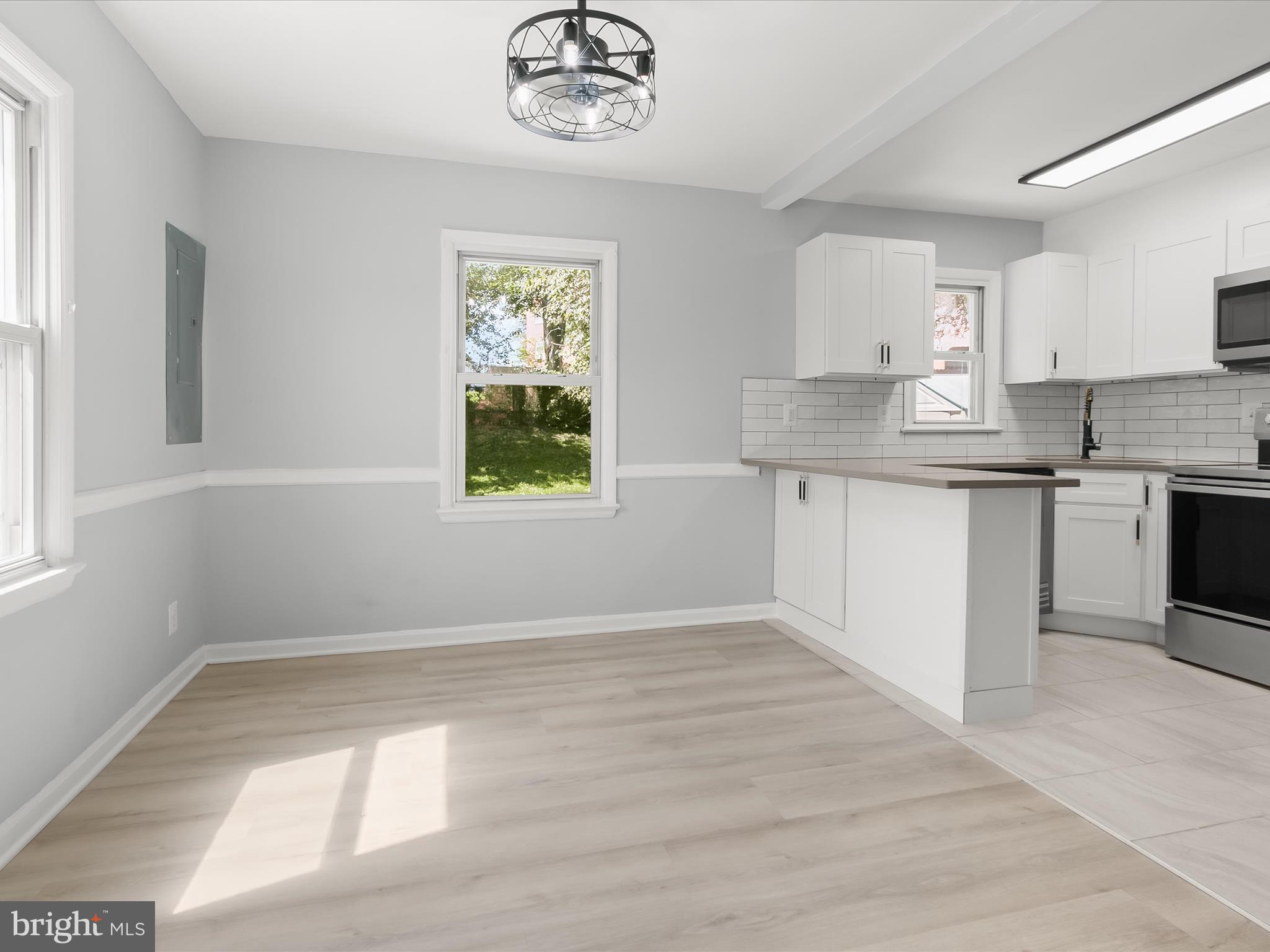 6806 10th Avenue Takoma Park, MD 20912 - Photo 13 of 39 a kitchen with a sink cabinets and window