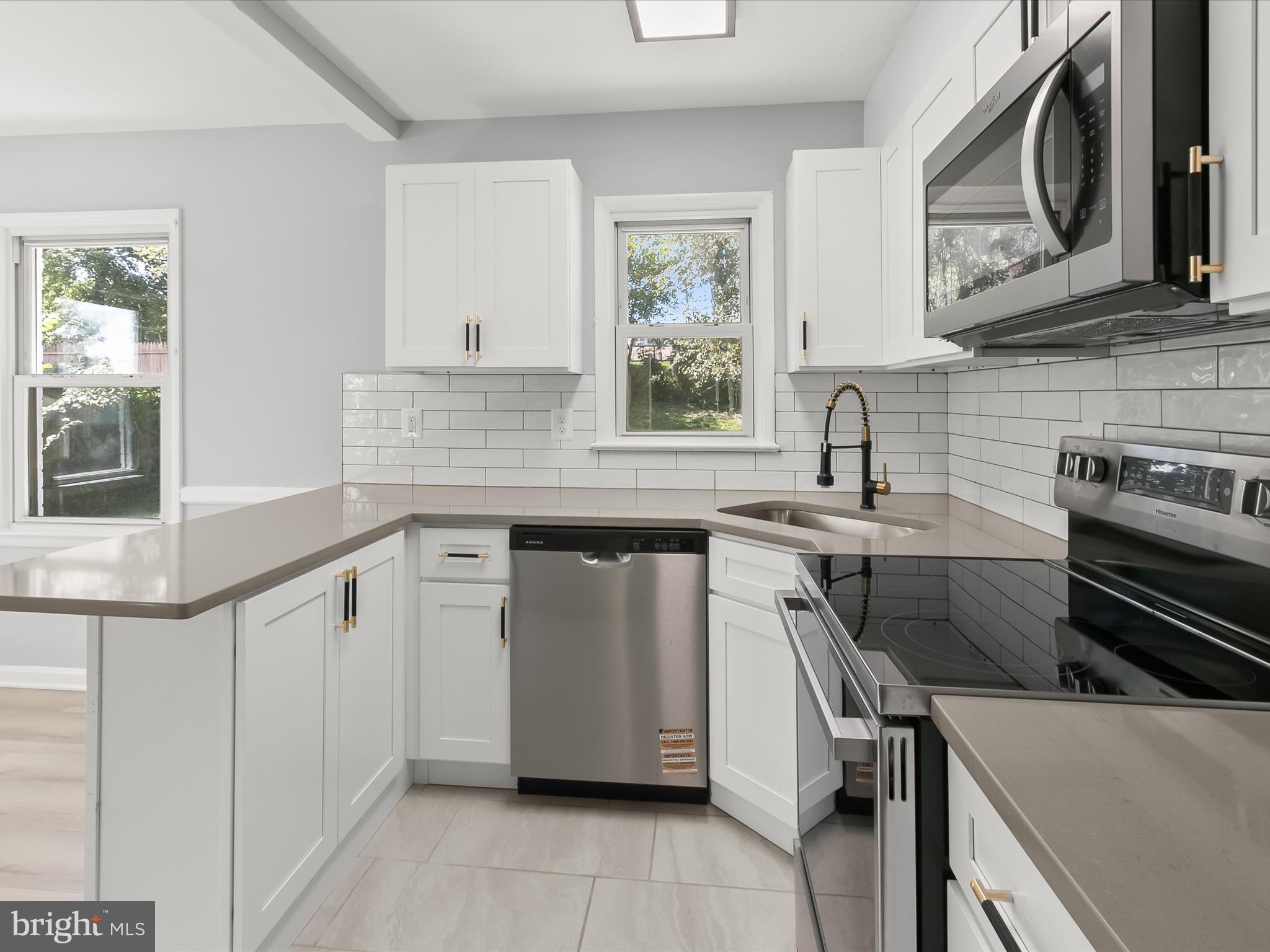 6806 10th Avenue Takoma Park, MD 20912 - Photo 18 of 39 a kitchen with stainless steel appliances a sink stove and cabinets