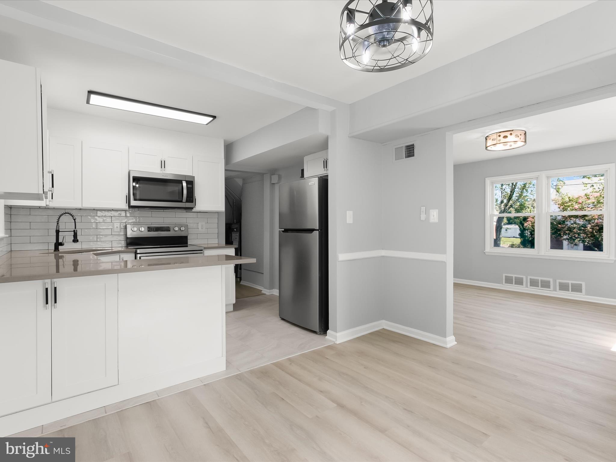 6806 10th Avenue Takoma Park, MD 20912 - Photo 2 of 39 a kitchen with stainless steel appliances granite countertop a refrigerator and a stove top oven