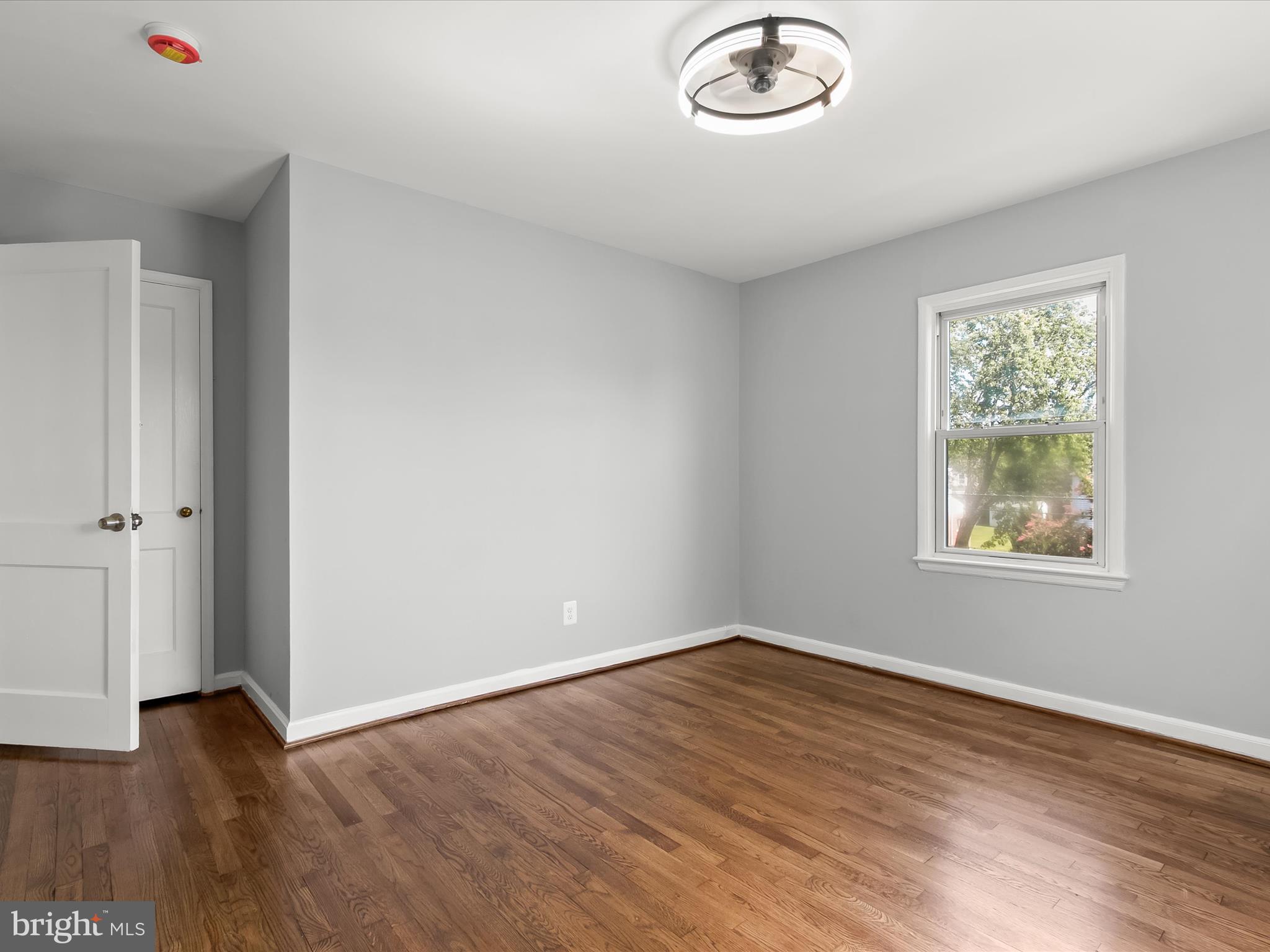 6806 10th Avenue Takoma Park, MD 20912 - Photo 25 of 39 an empty room with wooden floor and windows