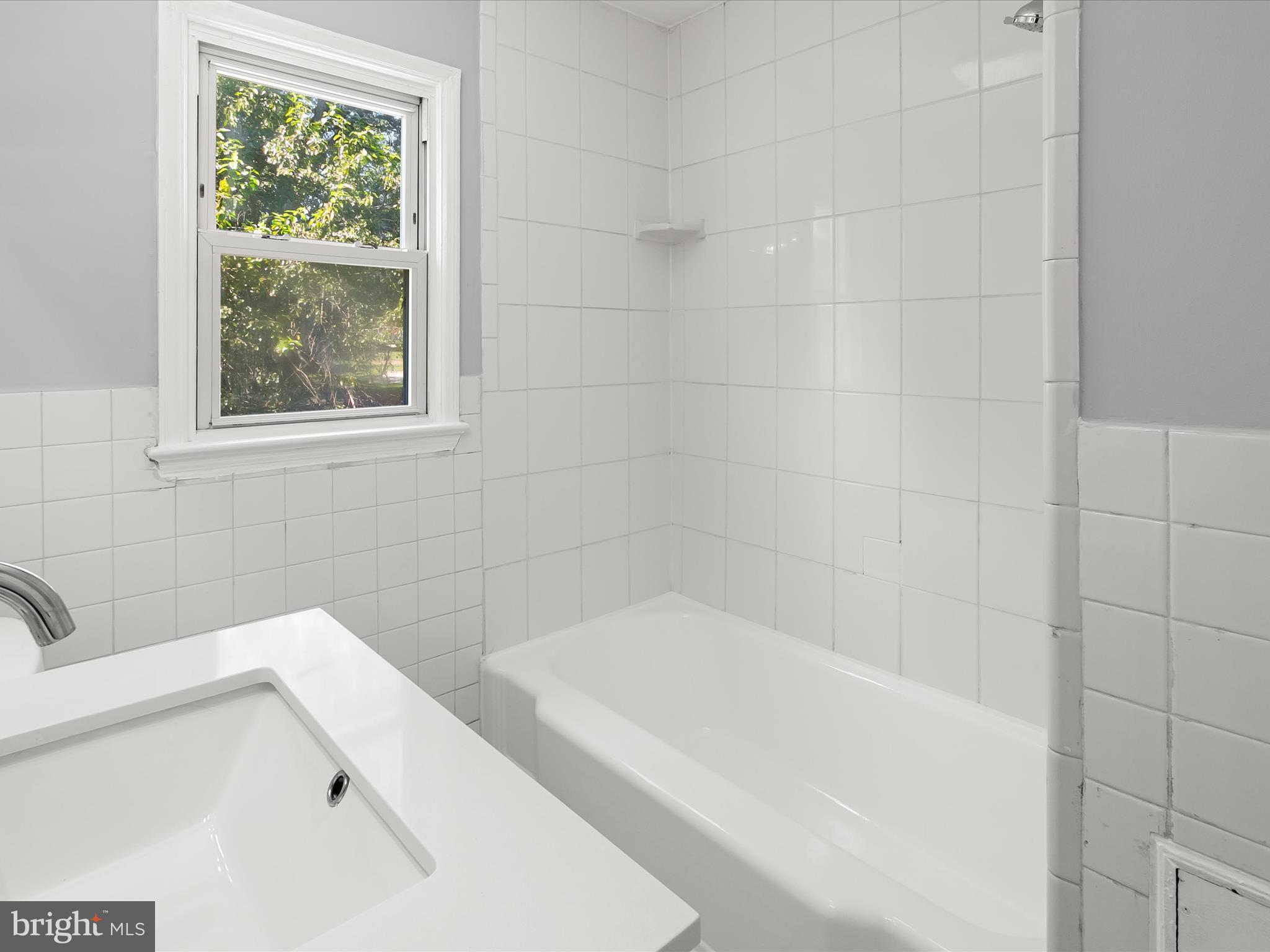 6806 10th Avenue Takoma Park, MD 20912 - Photo 27 of 39 a bath tub sitting next to a window