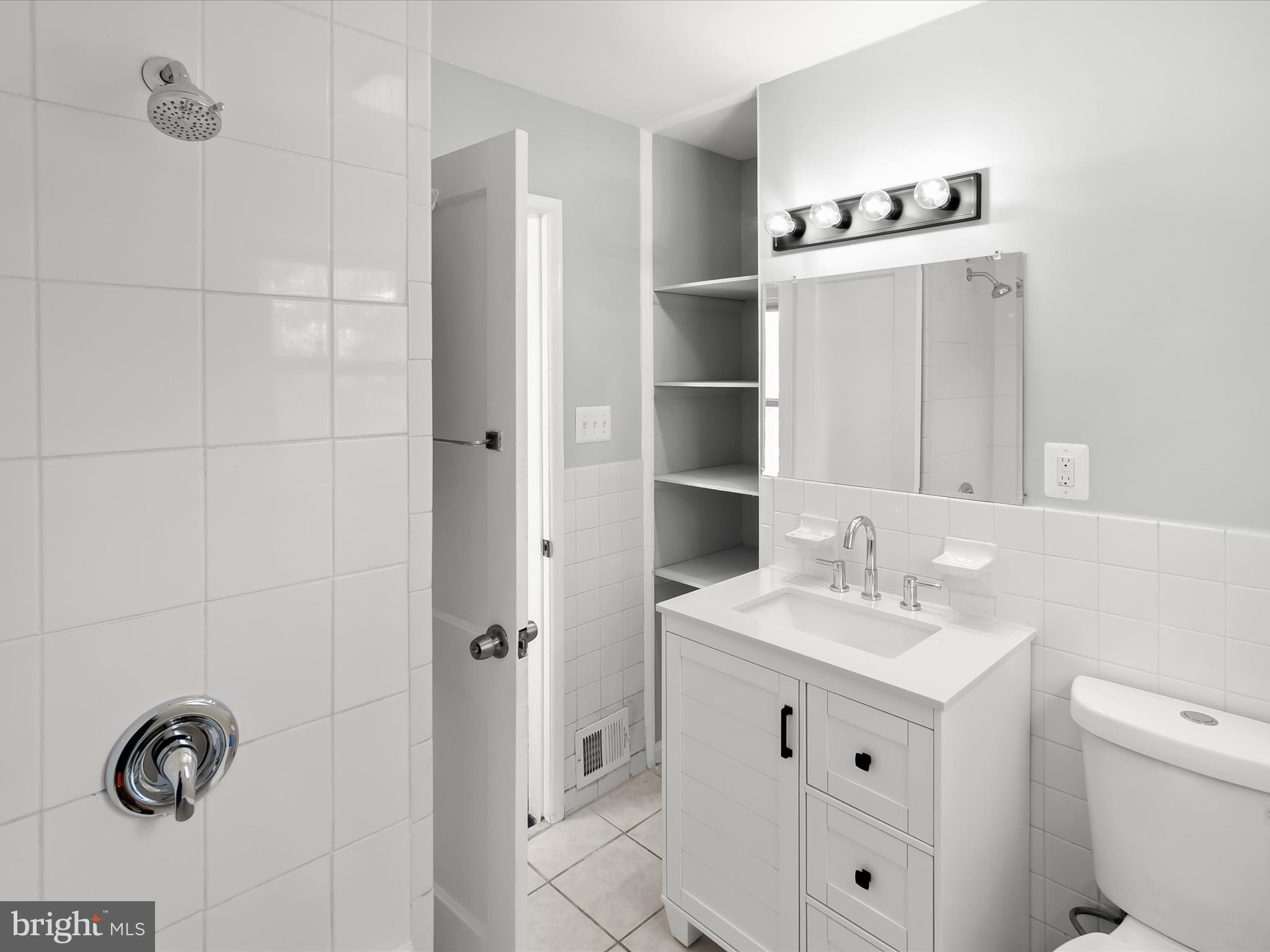 6806 10th Avenue Takoma Park, MD 20912 - Photo 29 of 39 a bathroom with a sink toilet and shower