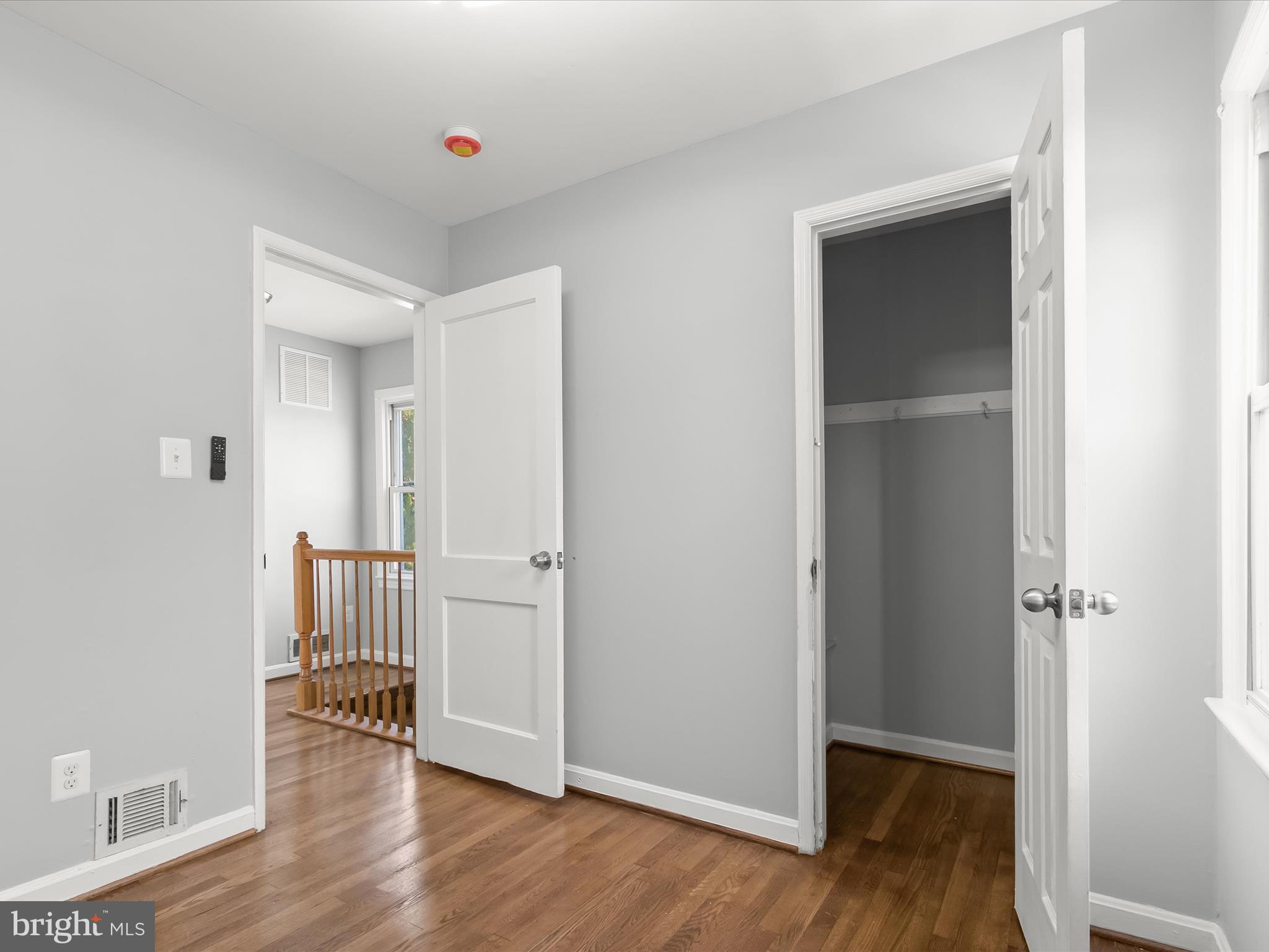 6806 10th Avenue Takoma Park, MD 20912 - Photo 34 of 39 an empty room with wooden floor and windows