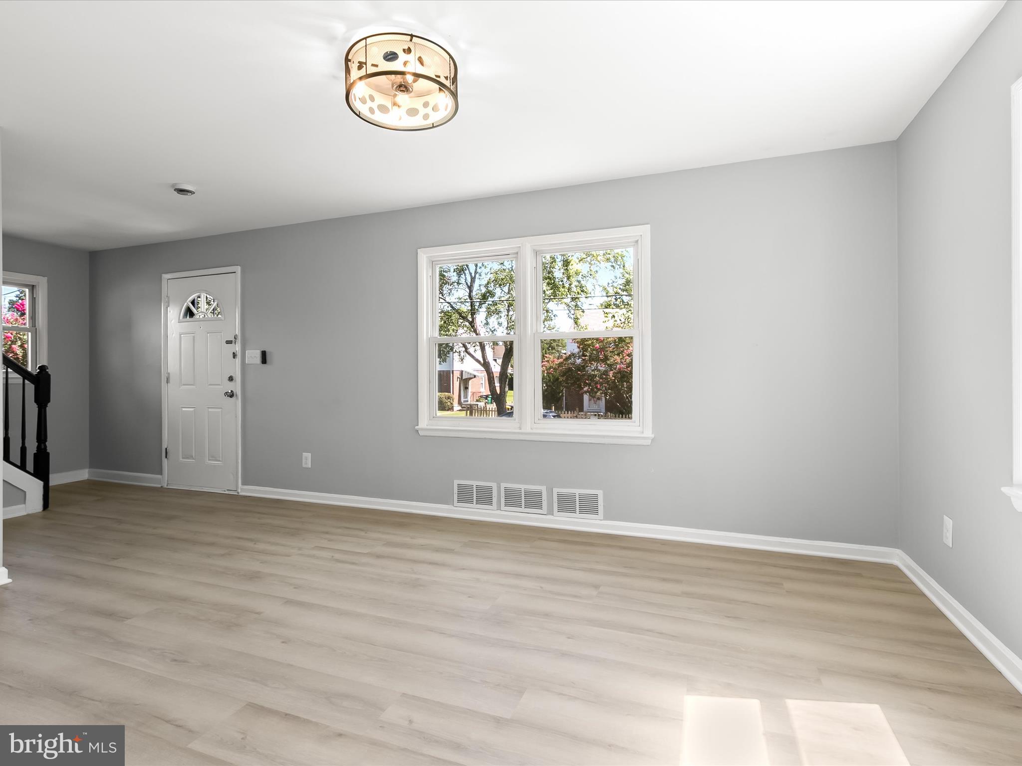 6806 10th Avenue Takoma Park, MD 20912 - Photo 10 of 39 an empty room with wooden floor and windows