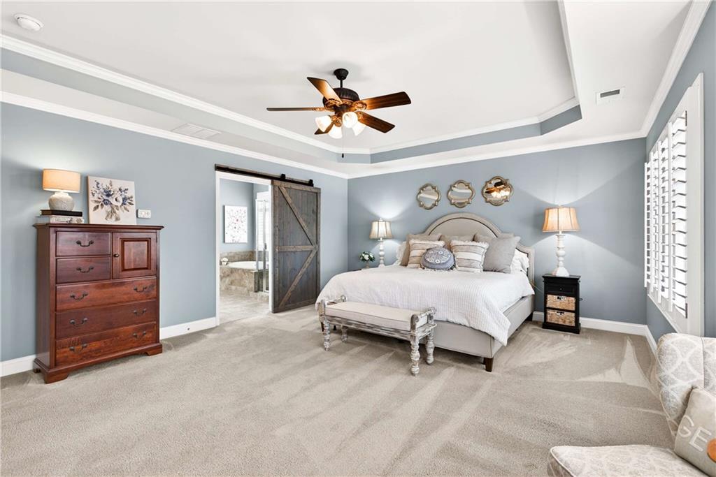 340 Scott Farm Drive Powder Springs, GA 30127 - Photo 25 of 59 a bedroom with a bed and a chandelier