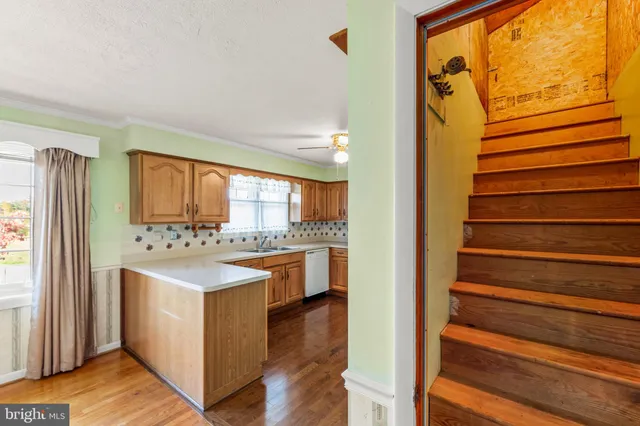 a kitchen with wooden cabinets and a window