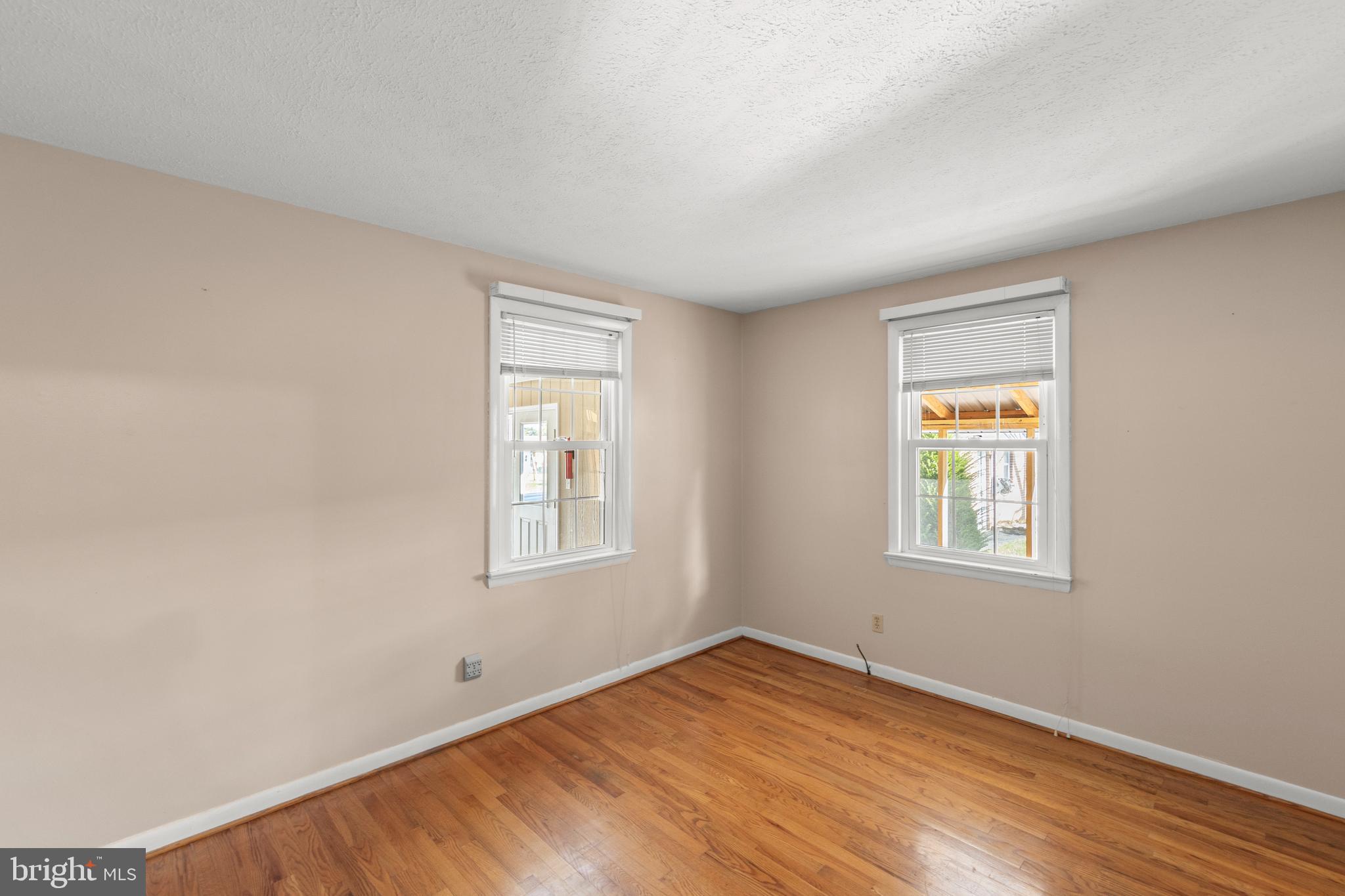 204 Ridge Road Winchester, VA 22602 - Photo 18 of 51 an empty room with wooden floor and windows