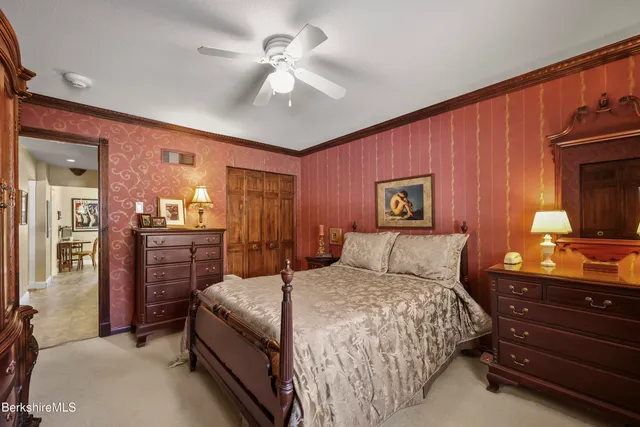 a bedroom with a large bed and a chandelier