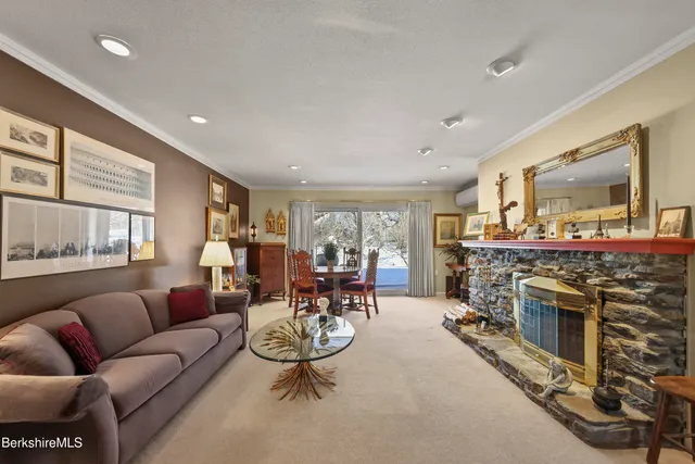 a living room with furniture a fireplace and a table
