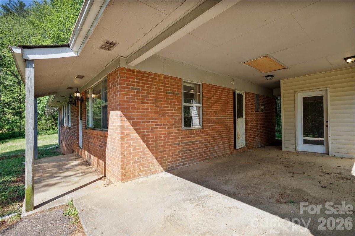 156 Old Sweetwater Road Robbinsville, NC 28771 - Photo 23 of 25 a view of a house with backyard and porch