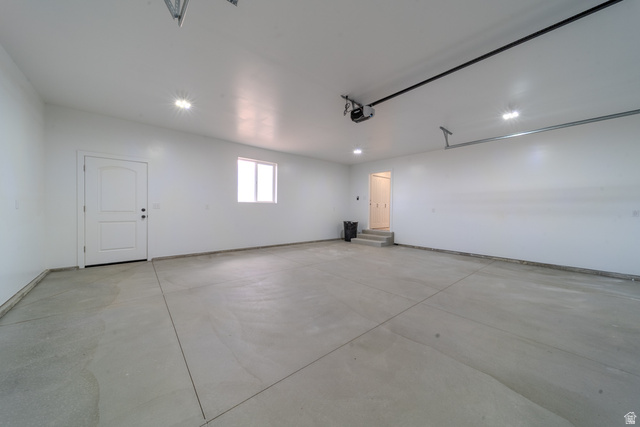 130 Pole Line Road, Unit 2 Roosevelt, UT 84066 - Photo 27 of 33 Spacious garage with a concrete floor, bright white walls, and recessed lighting