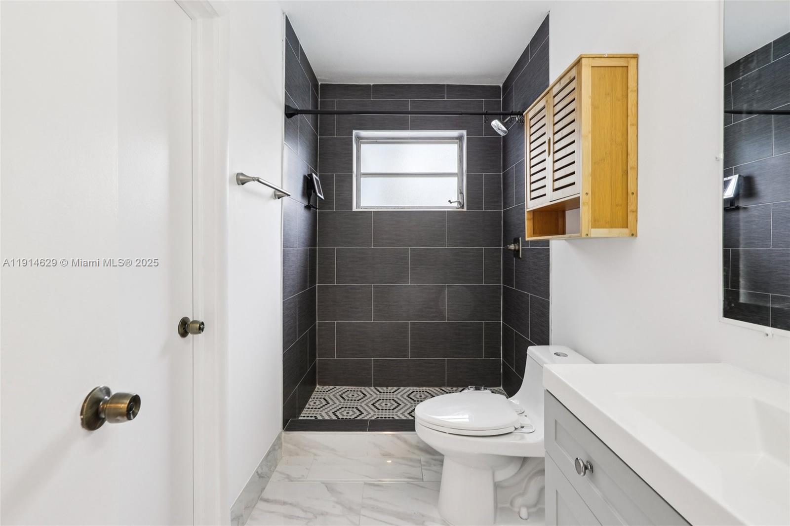 12630 Northeast Miami Place North Miami, FL 33161 - Photo 34 of 66 a bathroom with a sink a toilet and shower