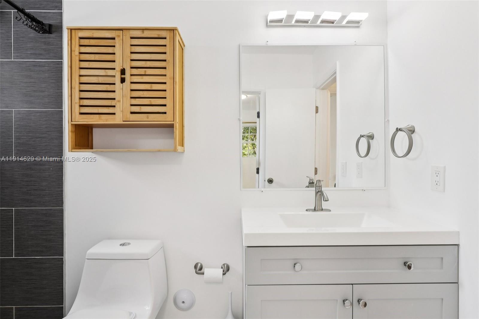 12630 Northeast Miami Place North Miami, FL 33161 - Photo 36 of 66 a bathroom with a sink a toilet and shower