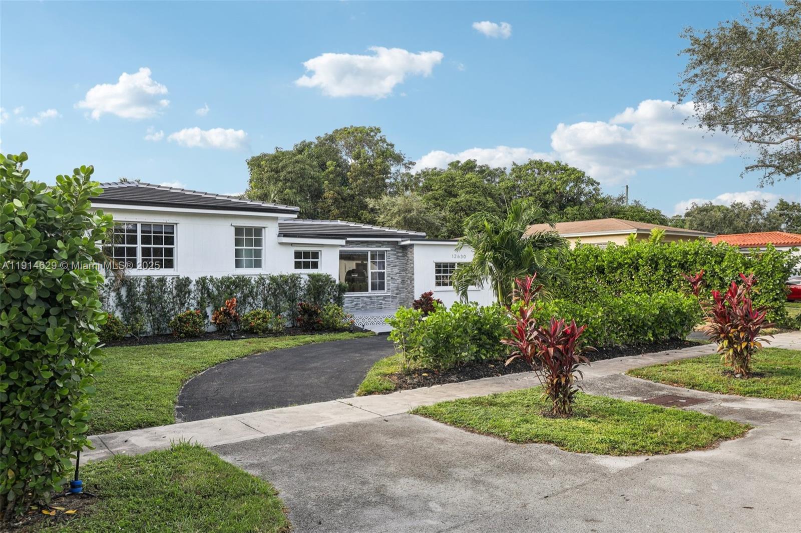 12630 Northeast Miami Place North Miami, FL 33161 - Photo 4 of 66 a house view with a garden space