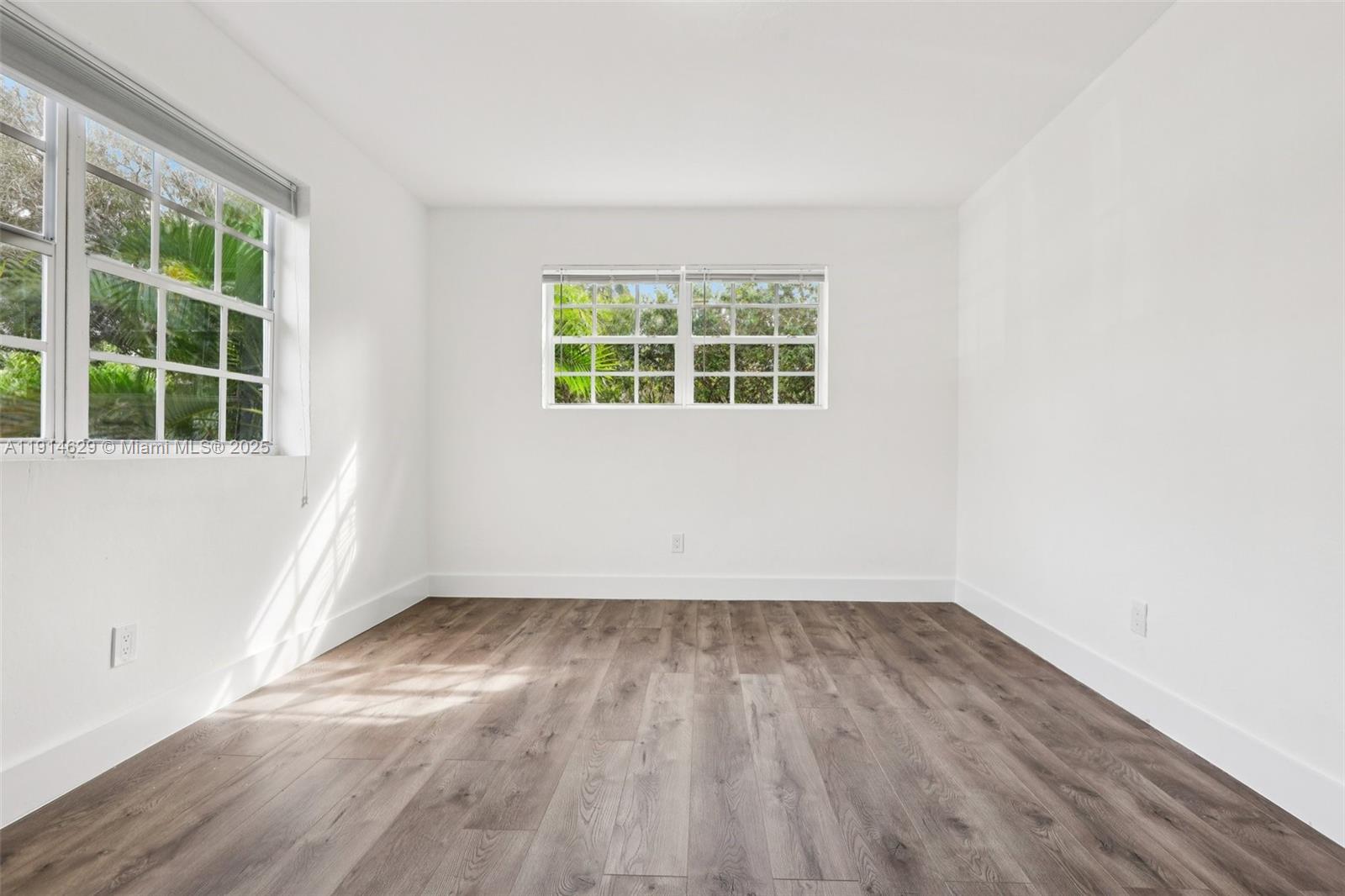 12630 Northeast Miami Place North Miami, FL 33161 - Photo 42 of 66 an empty room with wooden floor and windows