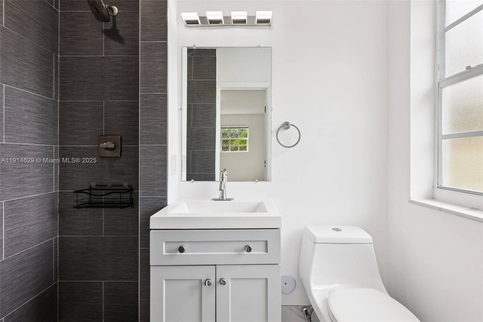 12630 Northeast Miami Place North Miami, FL 33161 - Photo 43 of 66 a bathroom with a sink toilet and shower