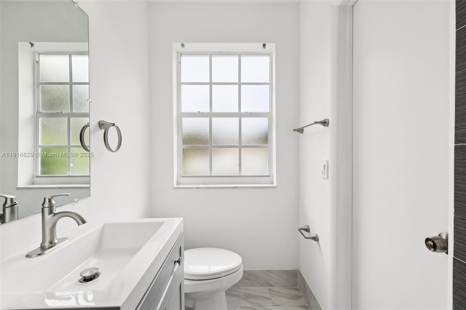 12630 Northeast Miami Place North Miami, FL 33161 - Photo 47 of 66 a bathroom with a sink and a mirror