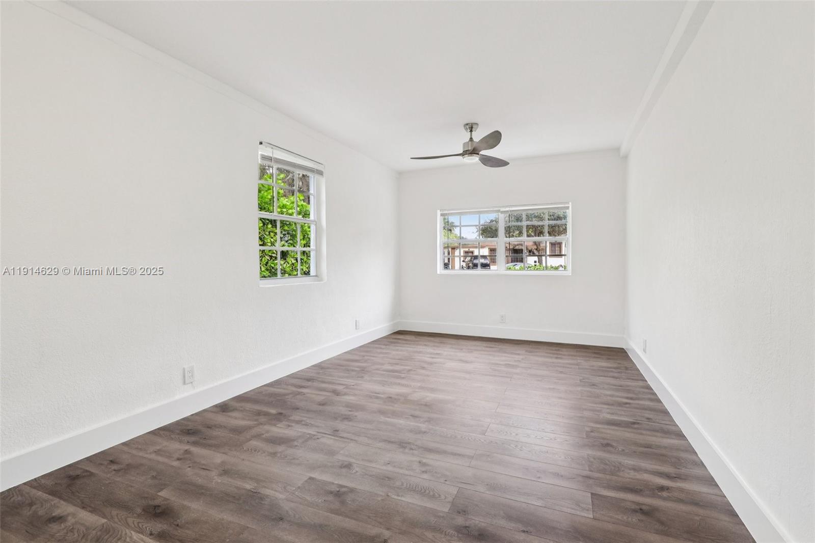 12630 Northeast Miami Place North Miami, FL 33161 - Photo 49 of 66 an empty room with a window and a ceiling fan