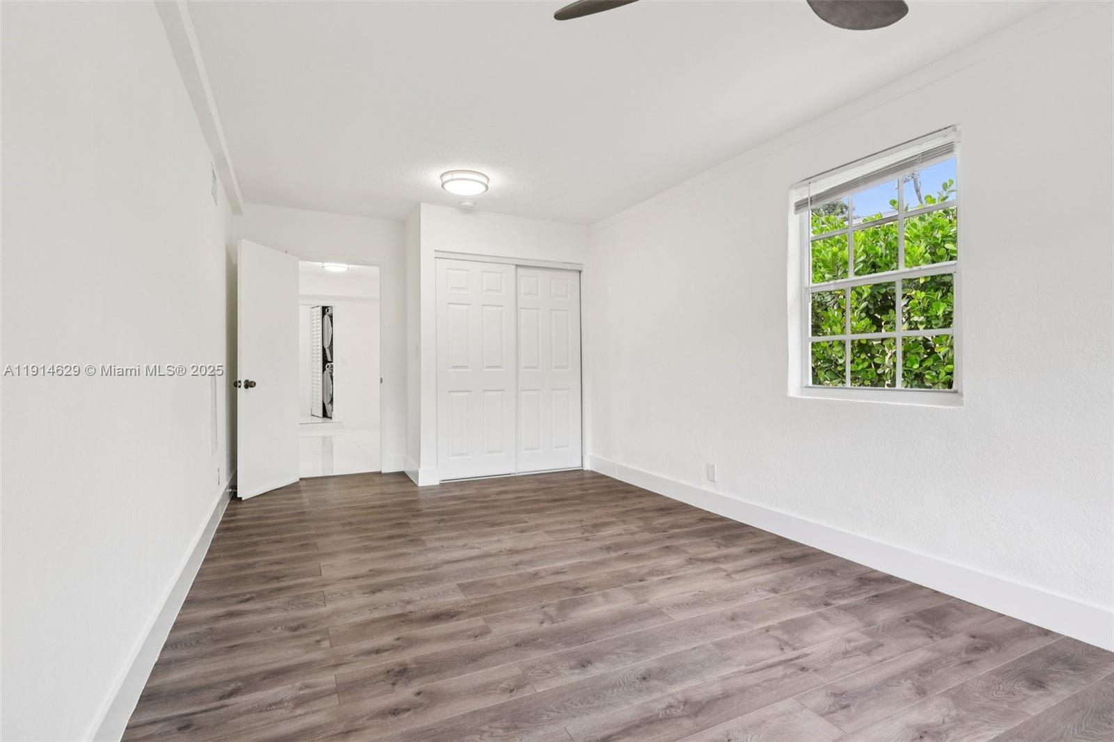 12630 Northeast Miami Place North Miami, FL 33161 - Photo 51 of 66 an empty room with wooden floor and windows
