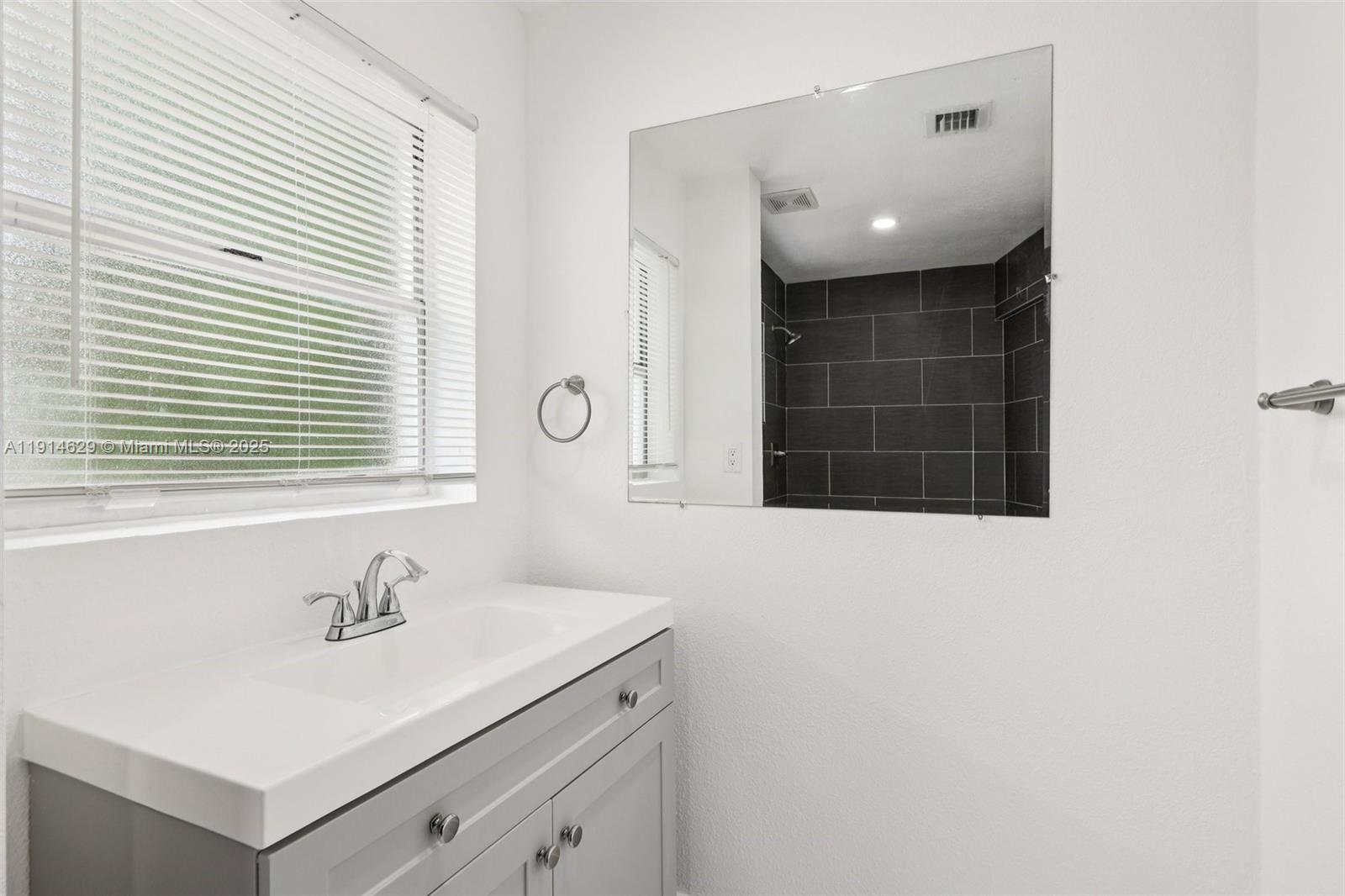 12630 Northeast Miami Place North Miami, FL 33161 - Photo 56 of 66 a bathroom with a sink and a mirror
