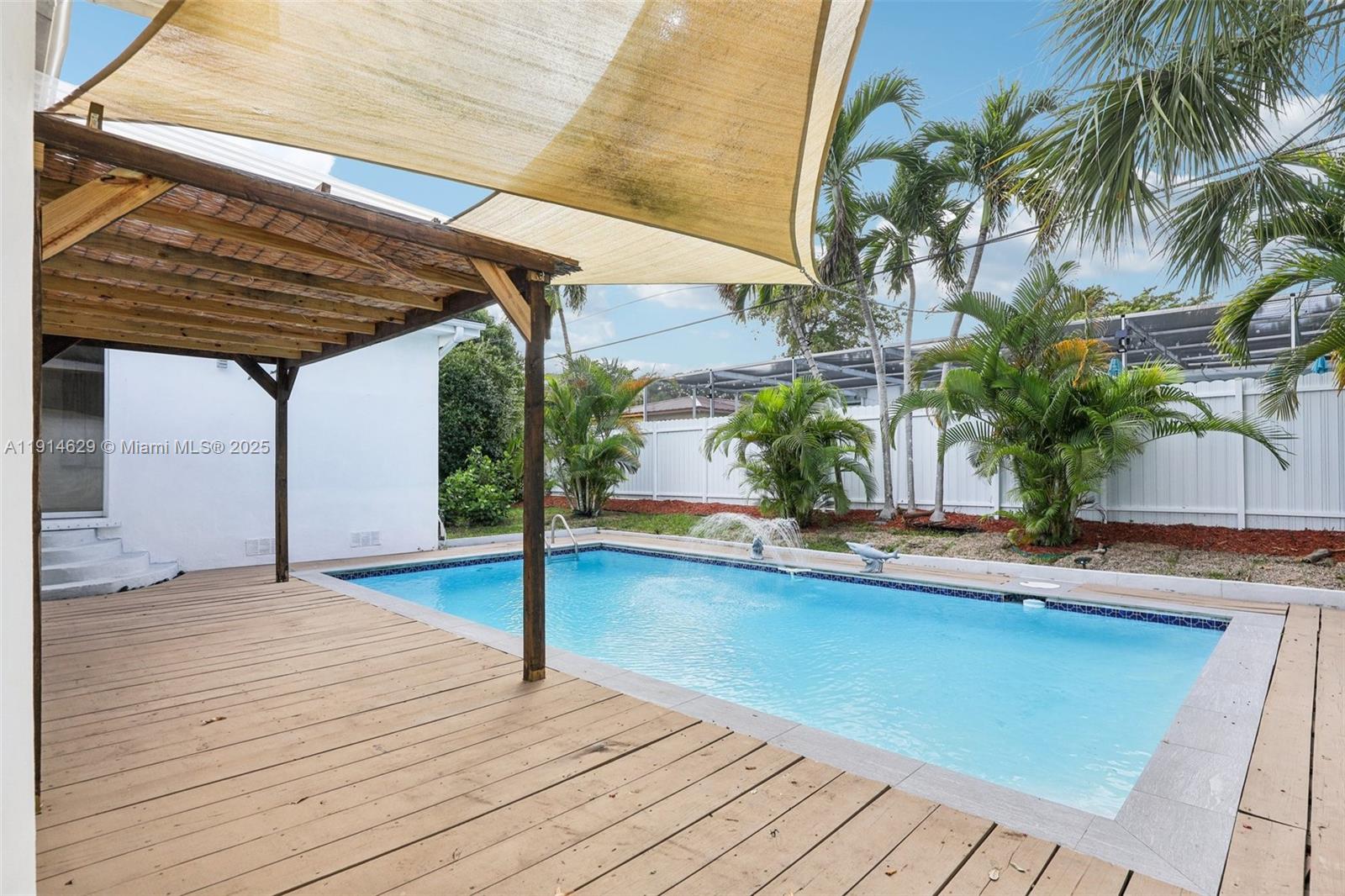 12630 Northeast Miami Place North Miami, FL 33161 - Photo 60 of 66 a backyard of a house with potted plants and palm tree