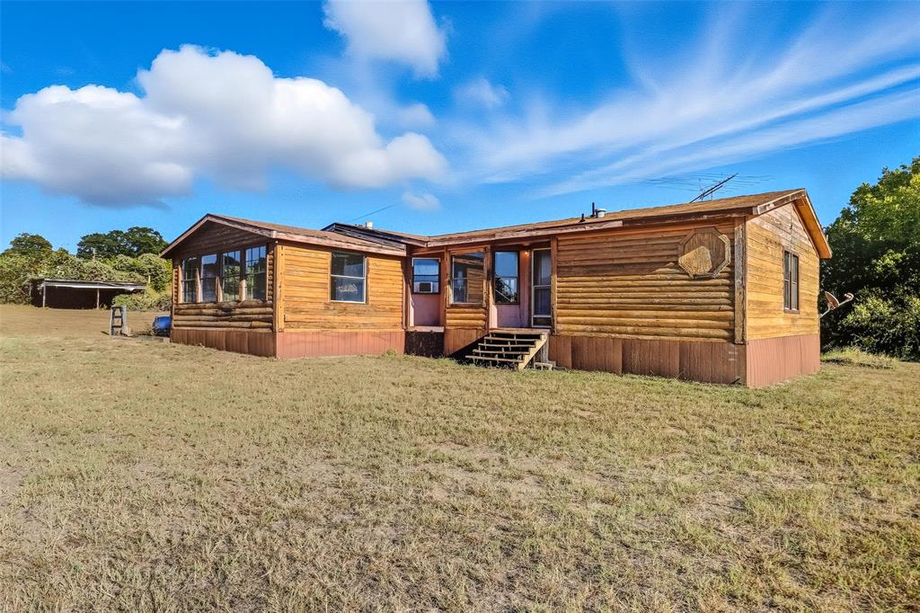 a view of a house with a backyard