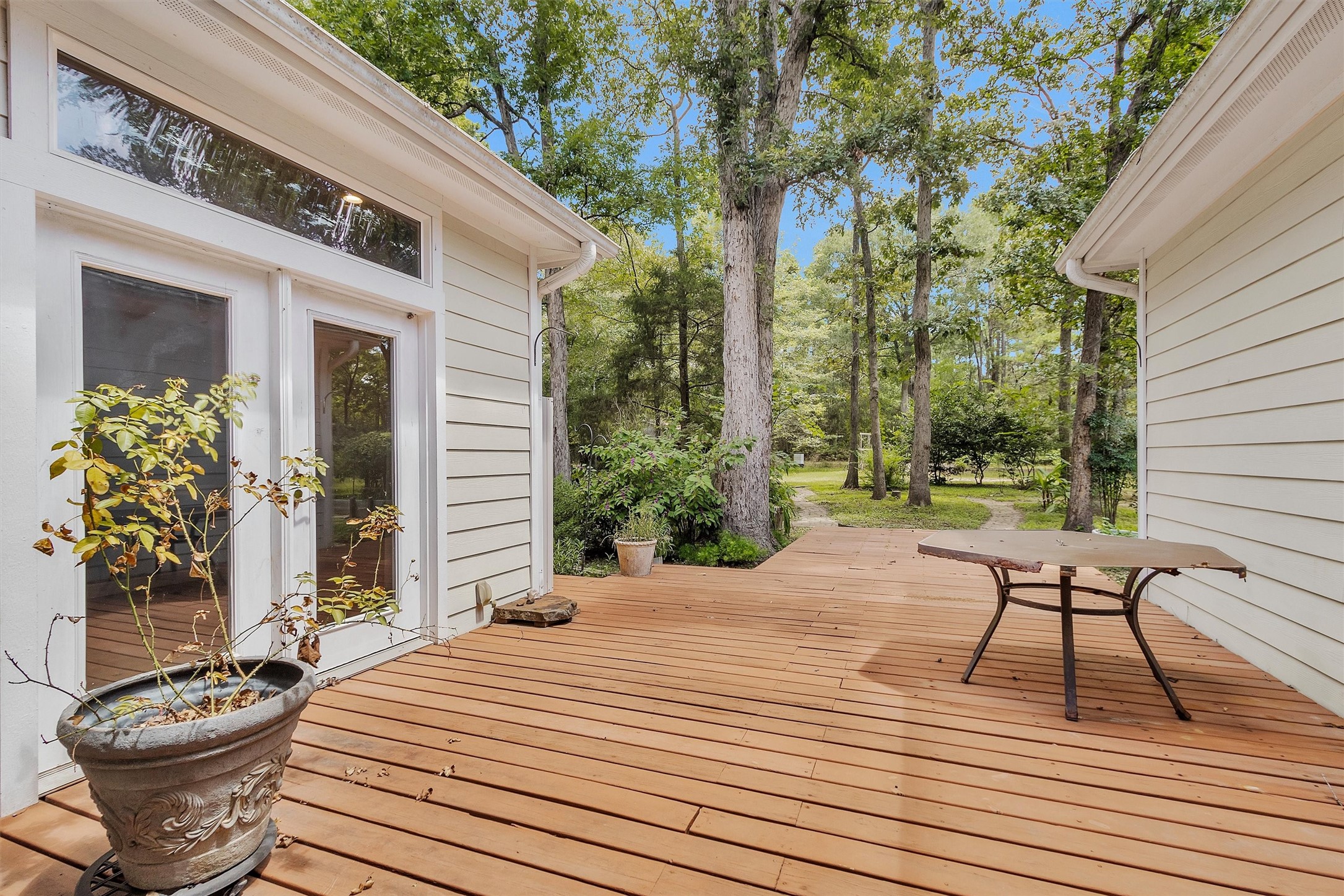 10331 Iron Ore Road Conroe, TX 77303 - Photo 30 of 47 Spacious wooden deck overlooking the property, perfect for outdoor relaxation and entertaining.