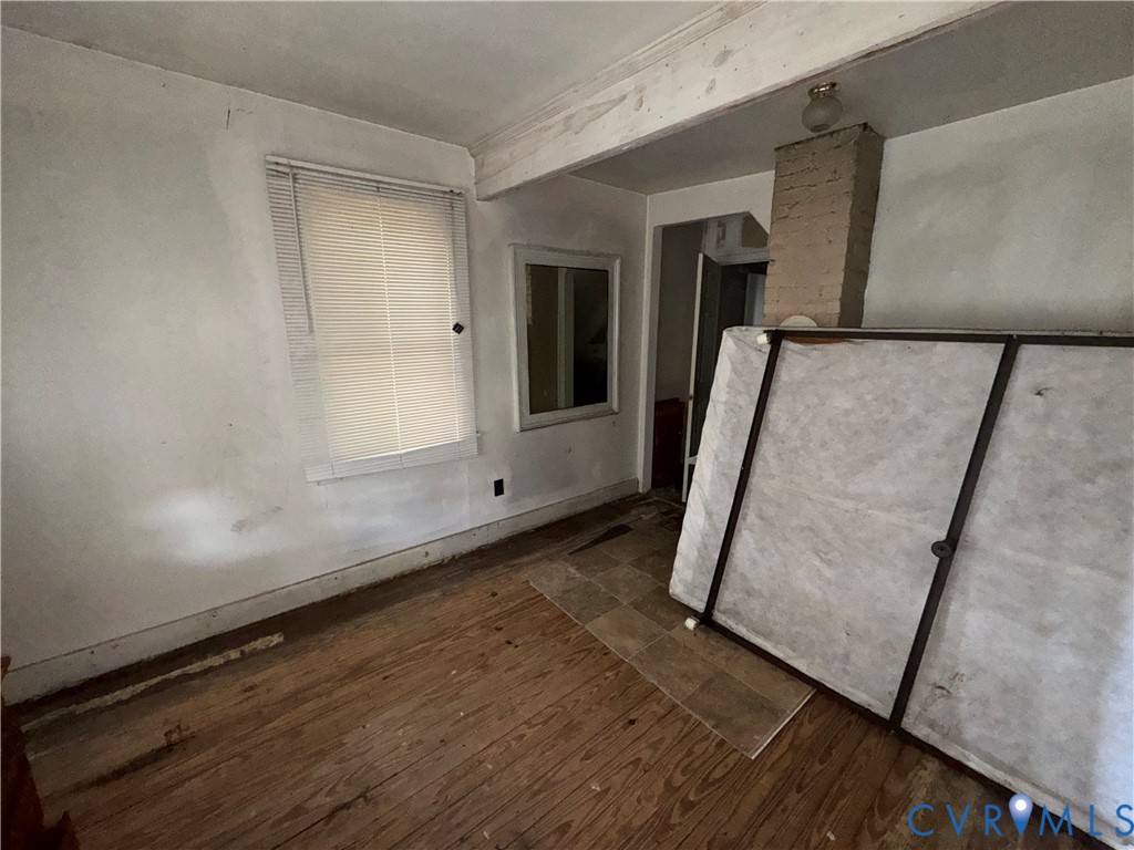 303 Purdy Road Emporia, VA 23847 - Photo 14 of 18 an empty room with wooden floor and door