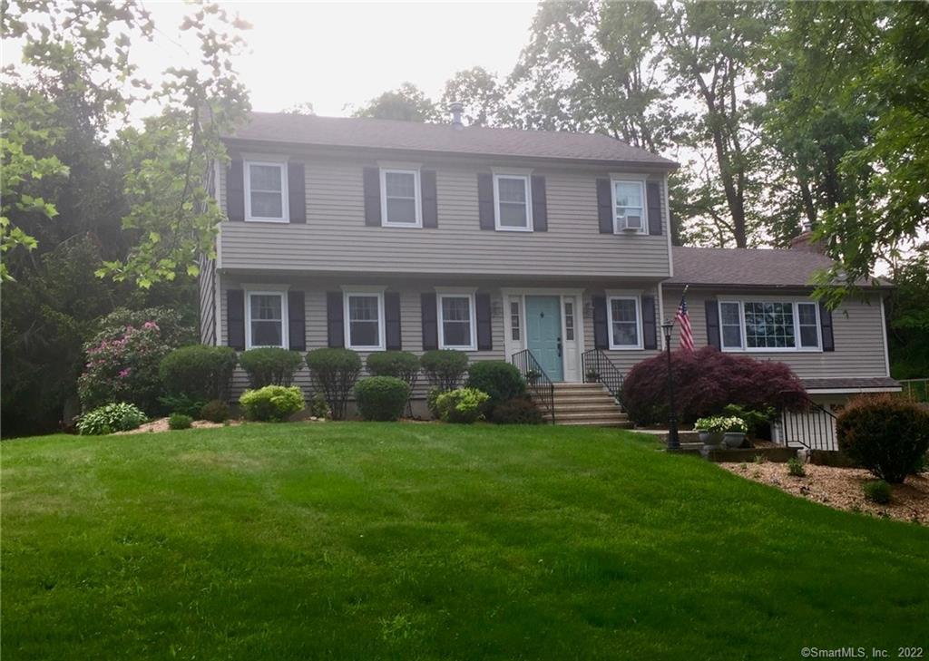 a front view of a house with garden and porch