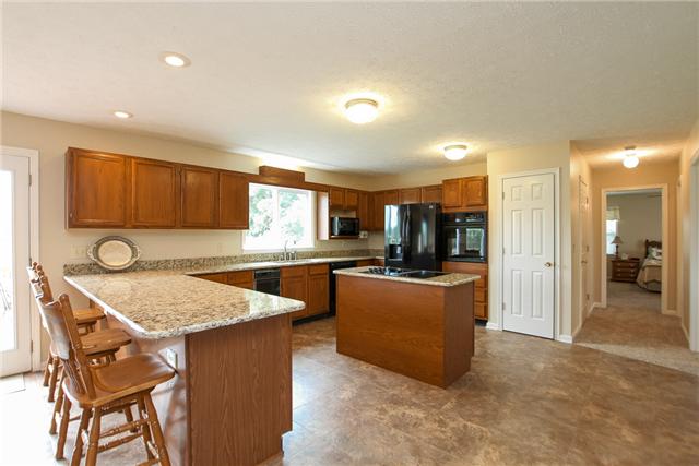 2021 Bradbury Road Adams, TN 37010 - Photo 2 of 20 Bright and airy kitchen with new granite countertops and black appliances