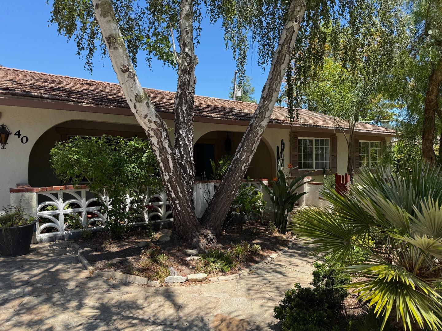 a front view of a house with garden