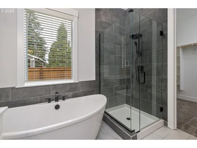 a bath tub sitting next to a shower