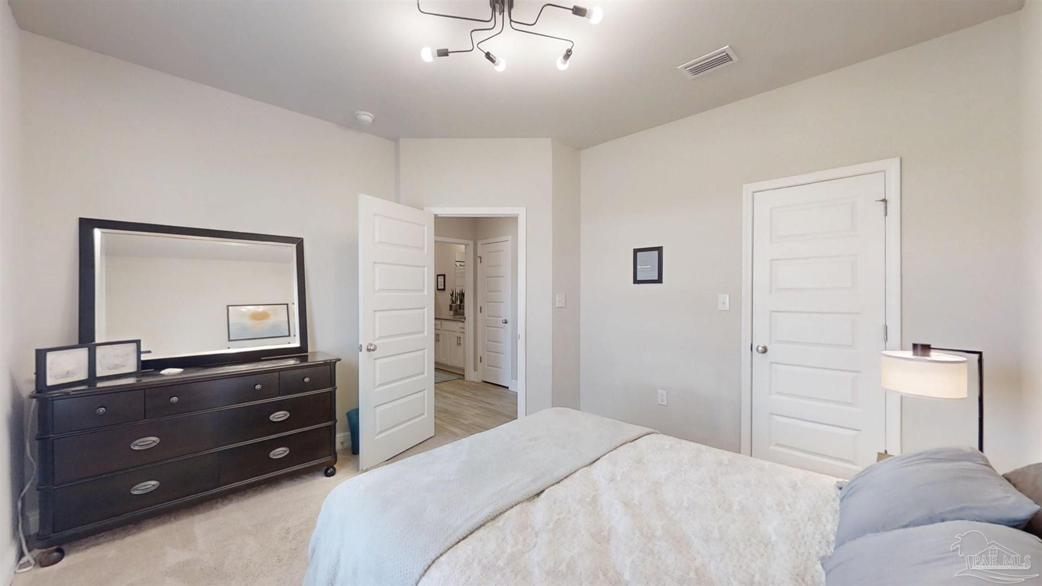 421 Apollo Avenue Gulf Shores, AL 36542 - Photo 14 of 72 a bedroom with a bed and a dresser