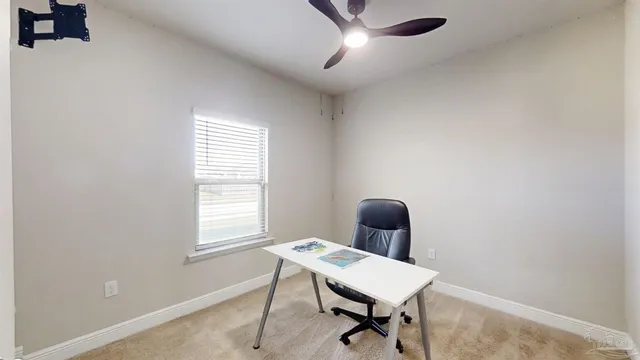a living room with furniture a flat screen tv and a large window