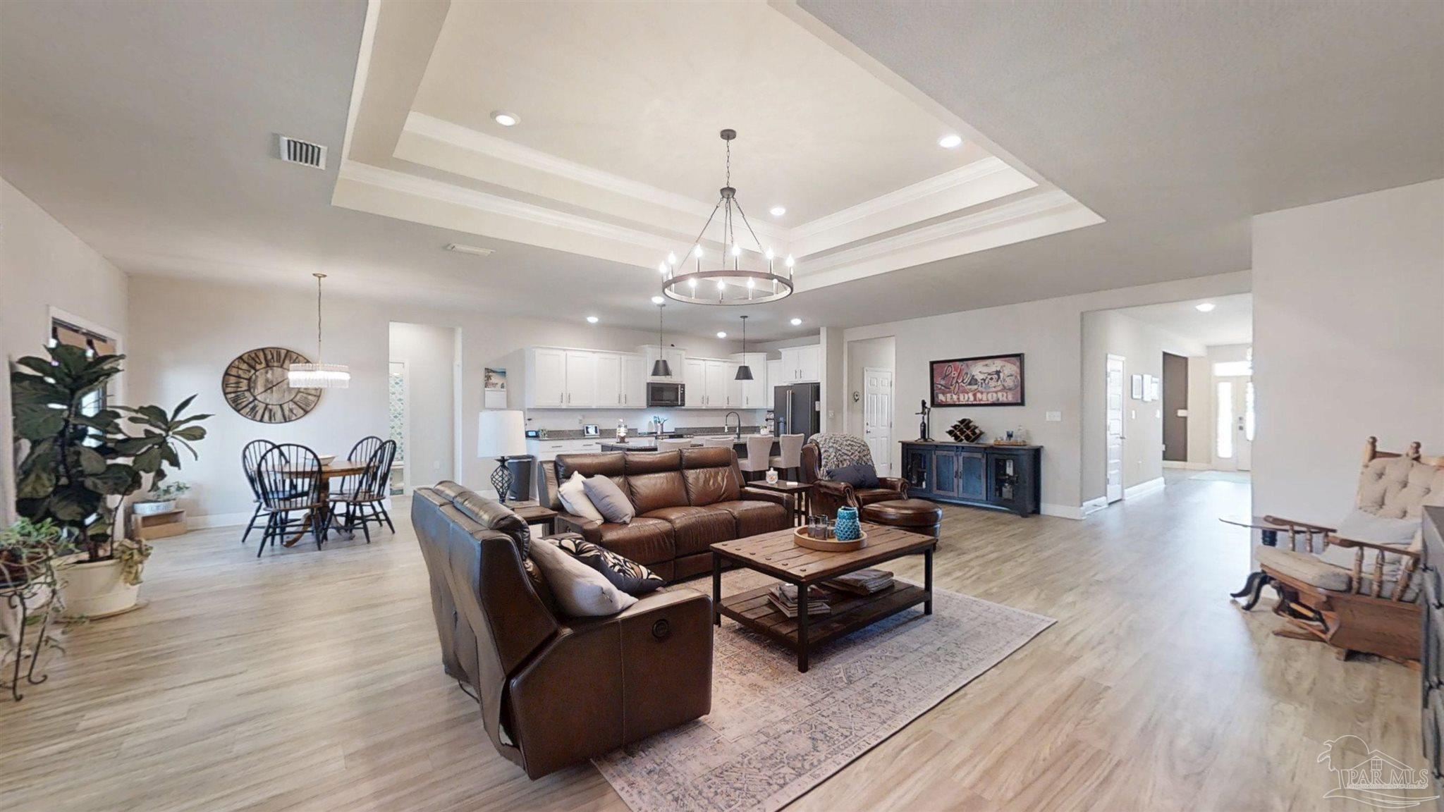 421 Apollo Avenue Gulf Shores, AL 36542 - Photo 19 of 72 a living room with furniture and a chandelier