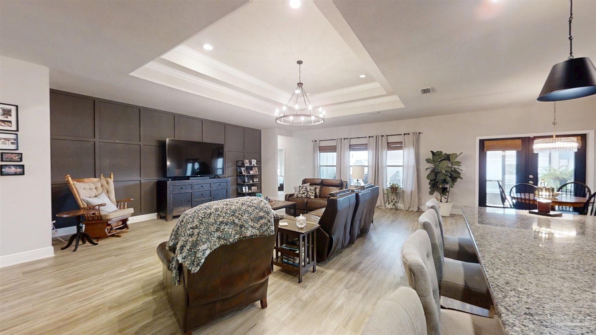 421 Apollo Avenue Gulf Shores, AL 36542 - Photo 21 of 72 a living room with furniture a flat screen tv and a large window